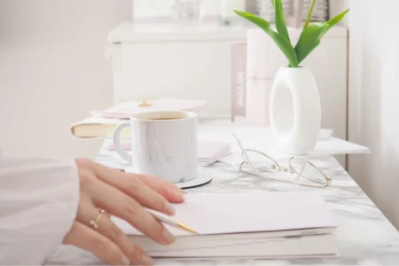 image illustrant des mains de femmes entrain d'écrire mon histoire avec l'endométriose sur un bureau